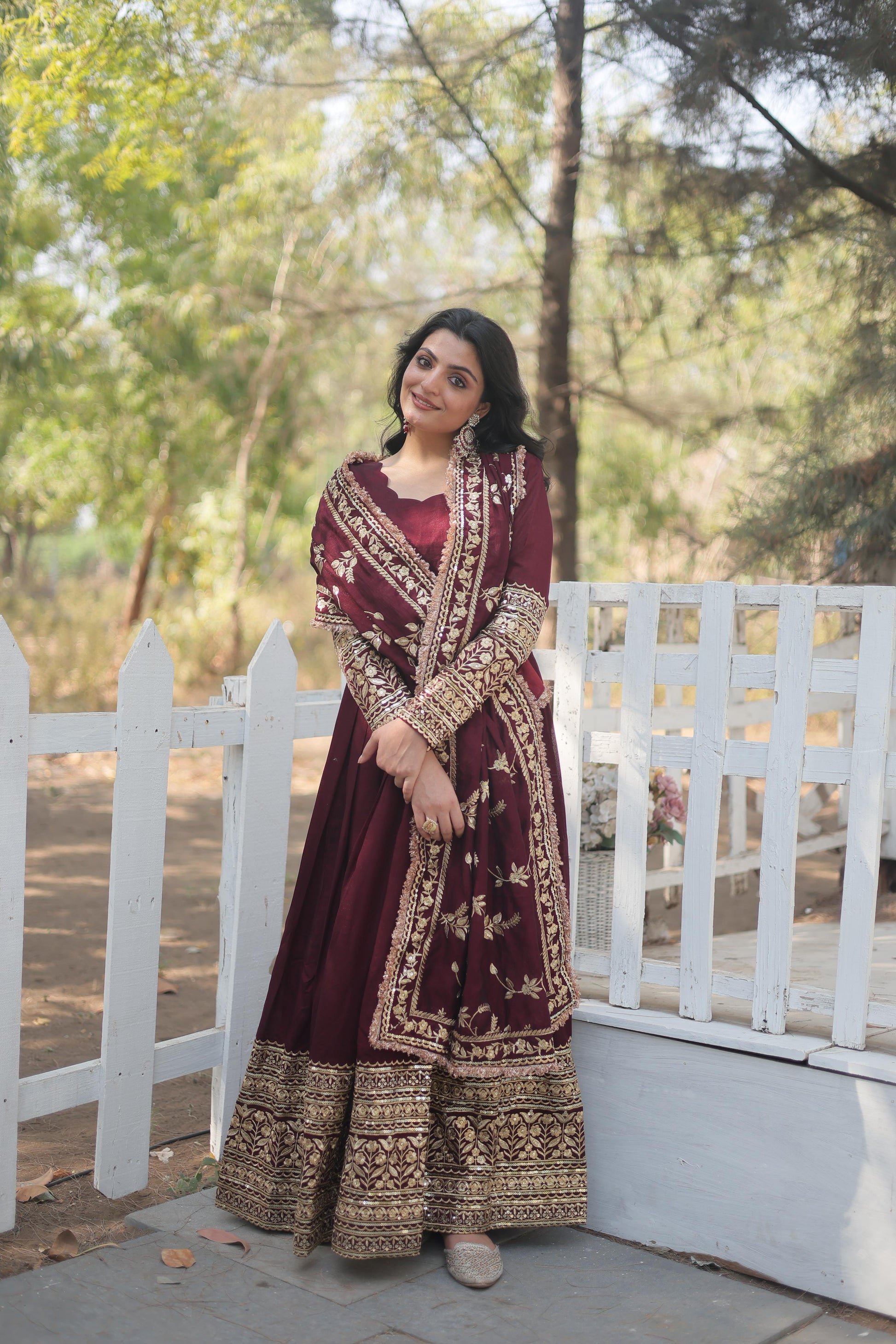Elegant maroon designer gown for women with intricate embroidery and embellished dupatta from KN Enterprises